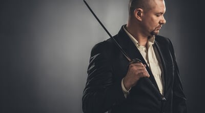 Thoughtful,Man,In,Suit,With,Katana,Sword,On,Black