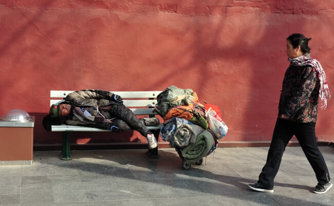 Beijing,-,Mar,112009:adult,Chinese,Woman,Looks,At,Homeless,Sleeping