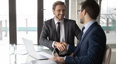 Smiling,Businessman,Shaking,Client,Hand,,Closing,Successful,Deal,,Sitting,At