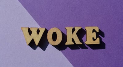 Woke,,Word,In,Wooden,Alphabet,Letters,Isolted,On,Purple,Background