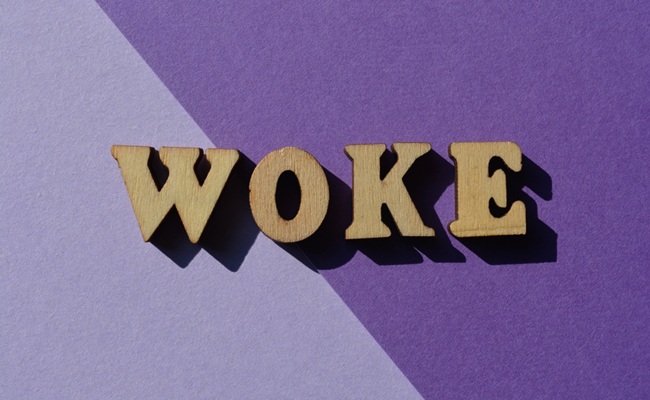 Woke,,Word,In,Wooden,Alphabet,Letters,Isolted,On,Purple,Background