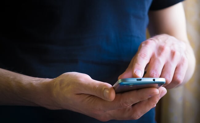 Close,Up,Of,A,Man,Using,Mobile,Smart,Phone