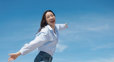 A,Cheerful,Asian,Woman,Enjoying,A,Sunny,Day,At,The