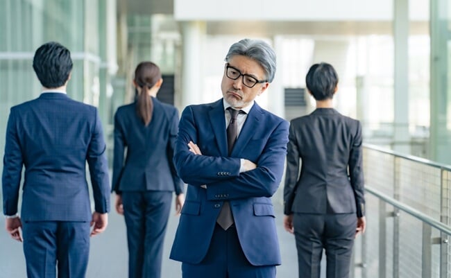 Senior,Male,Business,Person,Facing,Away,From,Subordinates,And,Worried