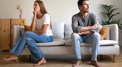 Young,Couple,Ignoring,Each,Other,Sitting,On,The,Couch.,Couple