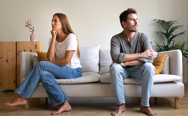 Young,Couple,Ignoring,Each,Other,Sitting,On,The,Couch.,Couple