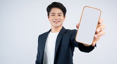 Portrait,Of,Young,Asian,Business,Man,Using,Phone,And,Posing