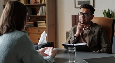 Man,Therapist,Listening,Attentively,To,Woman,Client,During,Therapy,Session,