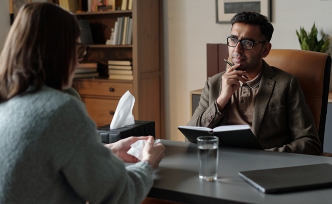 Man,Therapist,Listening,Attentively,To,Woman,Client,During,Therapy,Session,