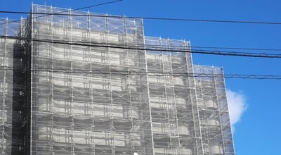 A,Condominium,Under,Construction,With,Scaffolding,Towering,In,The,Clear