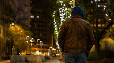 Rear,View,Of,Adult,Man,On,Street,At,Night,With