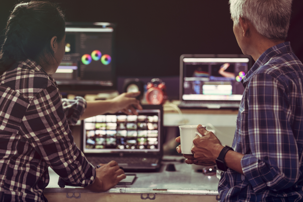 Producer,Creative,Senior,Man,And,Young,Woman,Editor,Working,Together