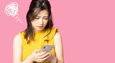 Depressed,Young,Asian,Woman,Watching,A,Smart,Phone.