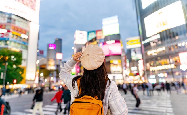 Young,Woman,Traveler,Walking,At,Shibuya,Crossing,The,Popular,Pedestrian