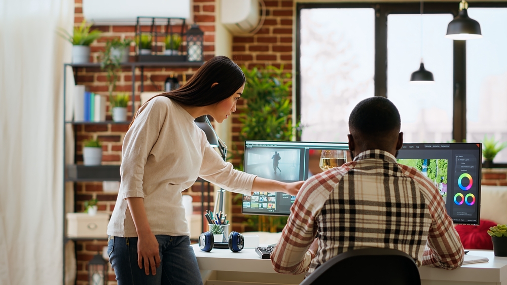 Creative,Interracial,Couple,Collaborating,On,Video,Editing,Process,,Discussing,Multiple