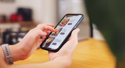 Hands,,Person,And,Phone,Screen,Of,Online,Shopping,With,Food