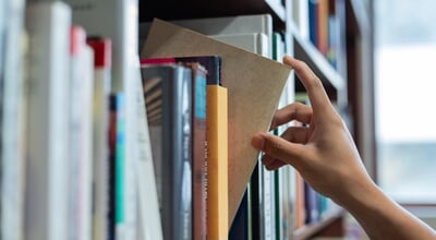 Right,Hand,Choosing,And,Picking,Book,In,Public,Library.
