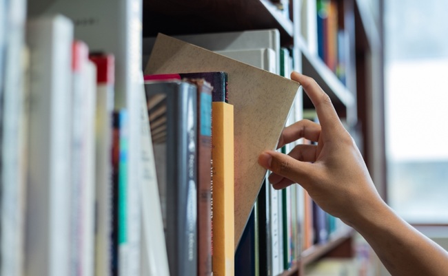 Right,Hand,Choosing,And,Picking,Book,In,Public,Library.