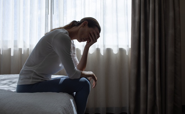Lonely,Sad,Woman,Sitting,On,Bed,In,Hotel,Feeling,Heart