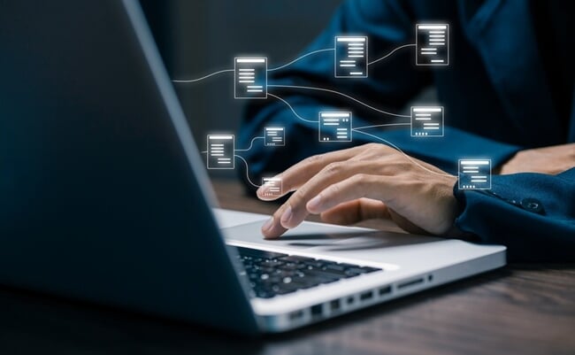 Hand,Typing,On,Laptop,With,Floating,Data,Flow,Nodes,,Representing