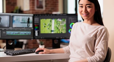 Portrait,Of,Female,Videographer,Editing,Movie,Footage,On,Computer,,Working