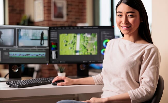 Portrait,Of,Female,Videographer,Editing,Movie,Footage,On,Computer,,Working