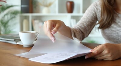 Close,Up,Of,A,Woman,Hands,Putting,Paper,Sheet,In