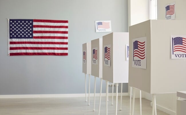 White,Empty,Voting,Booths,At,Polling,Station,With,American,Flag.