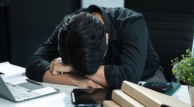 Young,Stressed,Asian,Businessman,Working,In,The,Office.,Businessman,Thinking