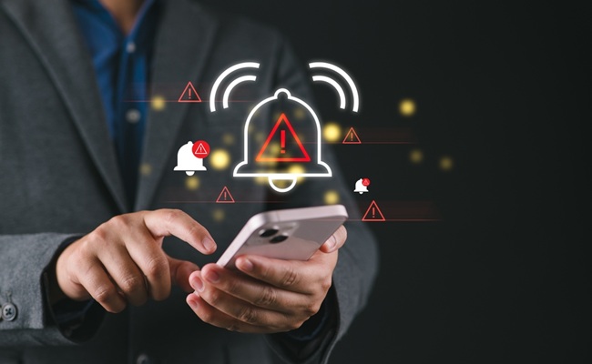 Corporate,Man,Handling,Emergency,Alert,Notification,On,Mobile,Phone,,Concept