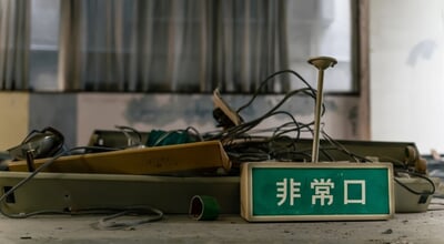 A,Pile,Of,Rubble,And,An,Emergency,Exit,Sign.,Japanese