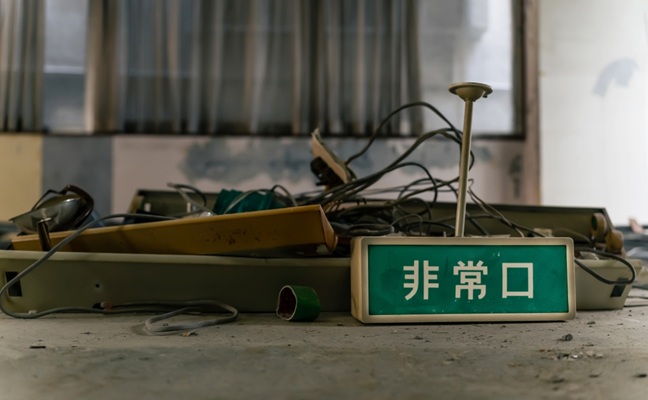 A,Pile,Of,Rubble,And,An,Emergency,Exit,Sign.,Japanese