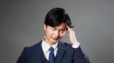 Asian,20s,Businessman,Having,A,Headache,In,Black,Background