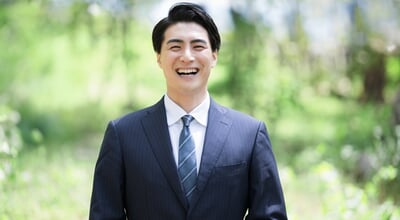 Japanese,Male,Businessman,In,Suit,Standing,Outdoors,With,Fresh,Greenery