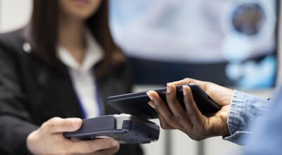 Patient,Using,Smartphone,For,Cashless,Medical,Payment,As,Clinic,Receptionist