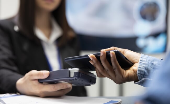 Patient,Using,Smartphone,For,Cashless,Medical,Payment,As,Clinic,Receptionist