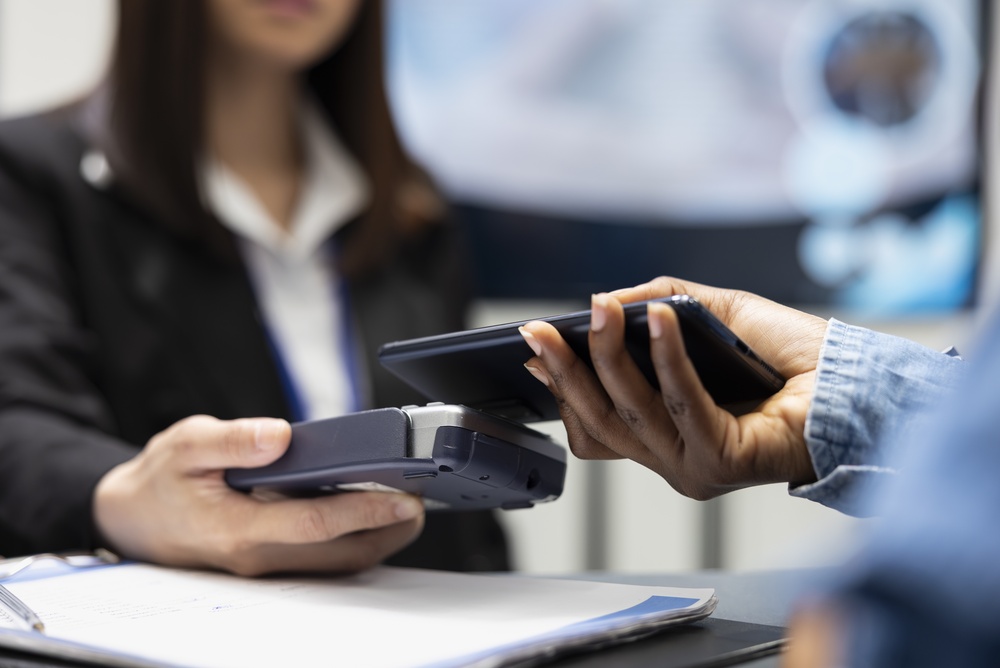 Patient,Using,Smartphone,For,Cashless,Medical,Payment,As,Clinic,Receptionist