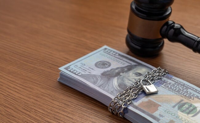 A,Judge's,Gavel,Next,To,A,Stack,Of,Money,Bound