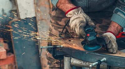 Close-up,Of,Manual,Worker,Operating,Grinder,With,Intense,Sparks,,Highlighting