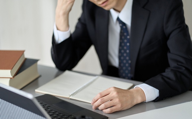 Worried,Asian,Businessman,Holding,His,Head