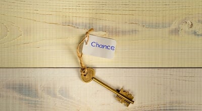 Bronze,Key,On,Light,Wooden,Planks,With,Lettering,Chance