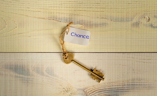 Bronze,Key,On,Light,Wooden,Planks,With,Lettering,Chance
