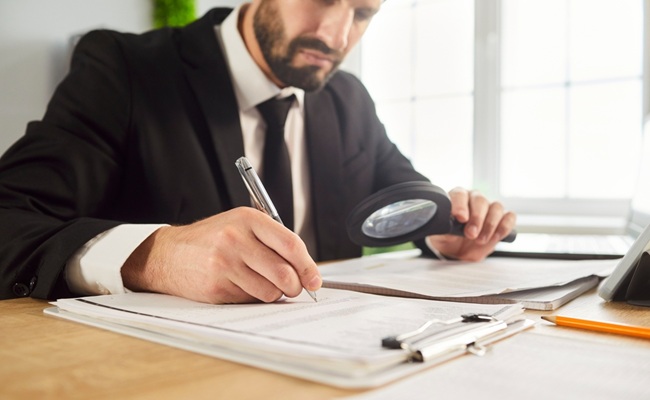 Business,Audit,,Scrutiny,Analysis,By,Businessman,Reading,Office,Documents,With