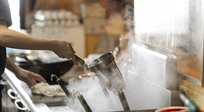 Japanese,Ramen,Chef,Draining,Noodles,In,A,Strainer,Over,A