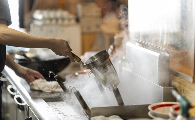 Japanese,Ramen,Chef,Draining,Noodles,In,A,Strainer,Over,A
