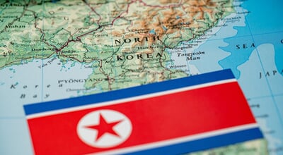 Close,Up,Of,North,Korea,Flag,On,Map,Of,North