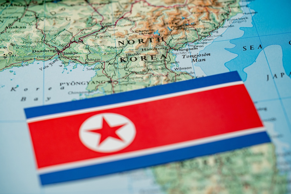 Close,Up,Of,North,Korea,Flag,On,Map,Of,North