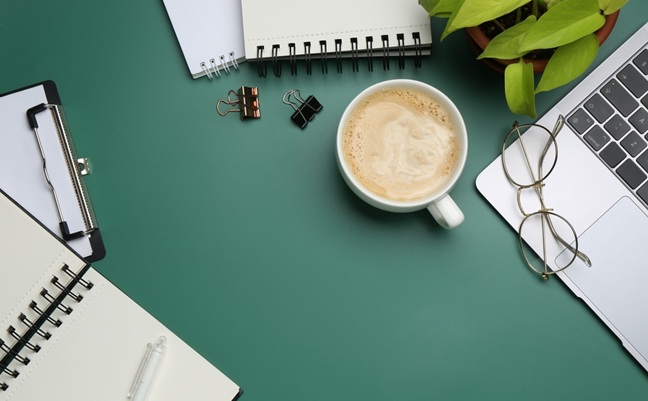 Office,Workplace.,Laptop,,Coffee,And,Stationery,On,Green,Desk,,Flat