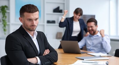 Man,Feeling,Jealous,Of,His,Colleague's,Success,In,Office,,Selective