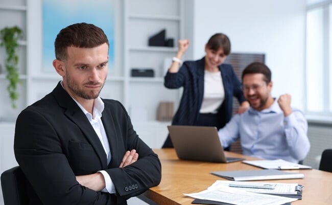 Man,Feeling,Jealous,Of,His,Colleague's,Success,In,Office,,Selective